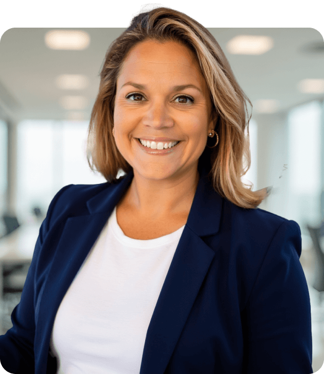 A person in a smart navy blazer and white shirt poses confidently in a modern office setting with blurred backgrounds.